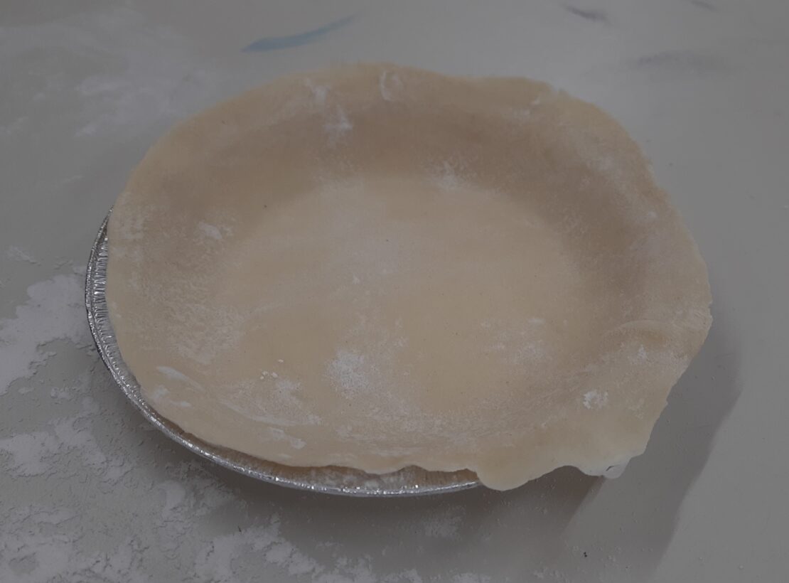 A 15cm pie case lined with thin pastry, ready to be blind baked.
