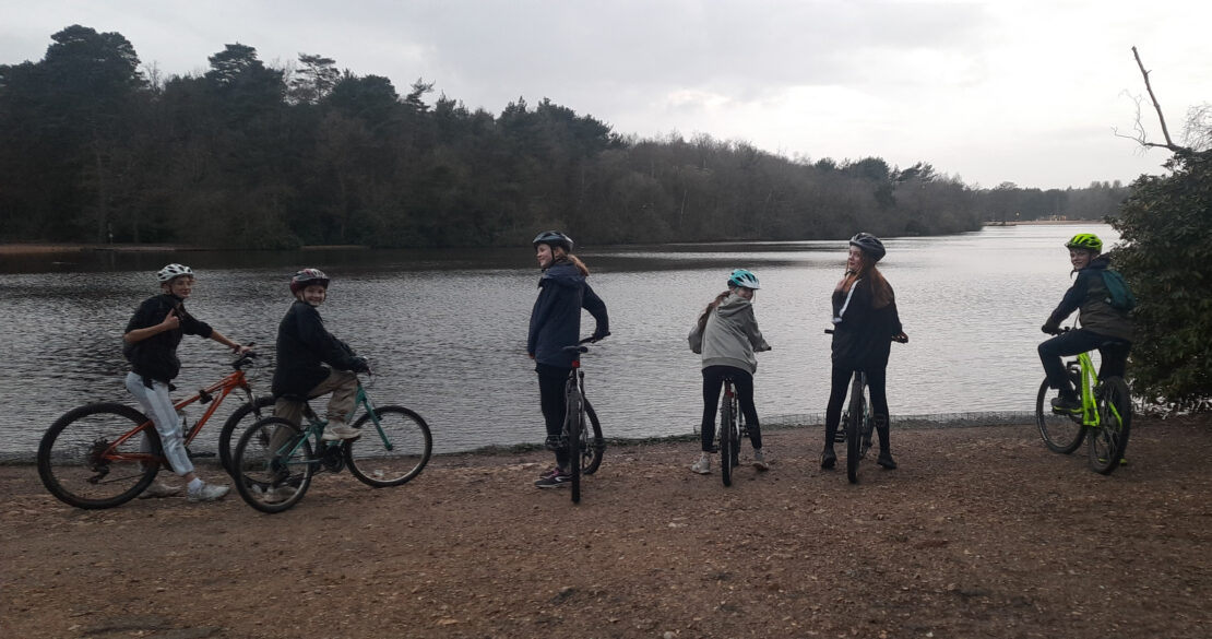 Half a dozen Scouts stand astride their bikes at the shore of Hawley Lake, beaming at the camera. The sun is just about to set and it's about to get very dark.